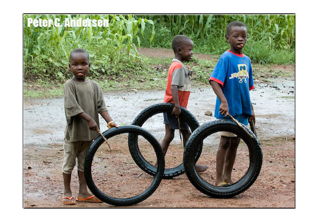 Children roll hoops made from motorcycle tires in Makeni.